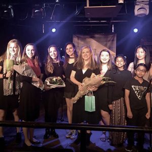Amy posts with vocal students after a recital