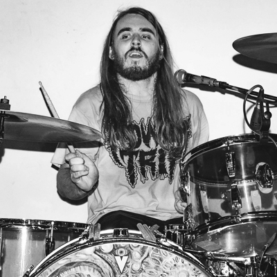 Drummer with long hair at drum set