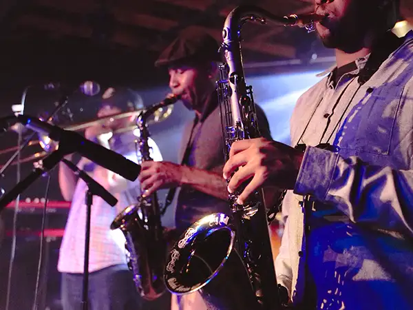 Musicians on stage playing saxophones